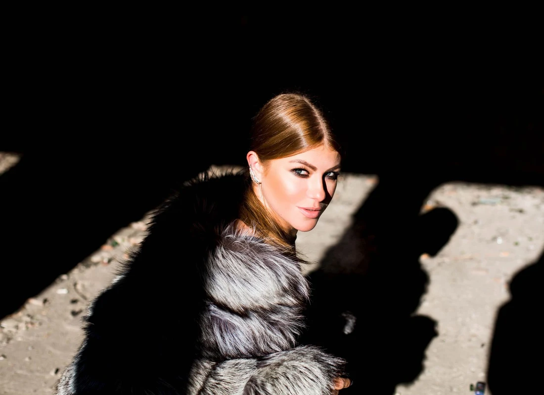 Fashion model in dramatic silhouette wearing archival coat