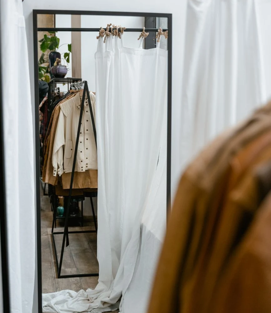 Client in private atelier fitting room with personal stylist